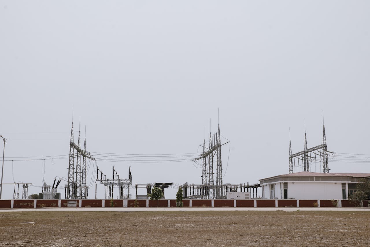 An industrial power station under a clear sky, showcasing electrical infrastructure and technology.
